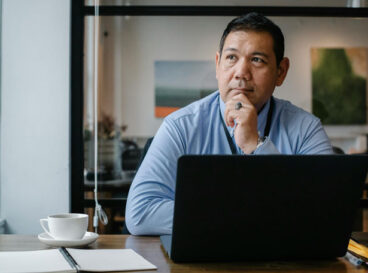 hoa electronic voting advice man thinking at computer desk